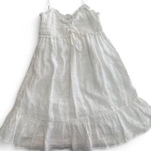 White cotton babydoll dress with ruffles and tie detail